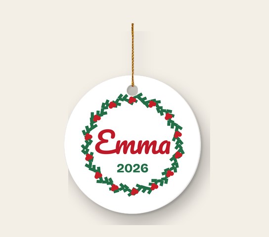 White ceramic circle ornament with a wreath and the name Emma